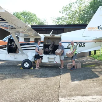 Loading food packs onto plane for delivery